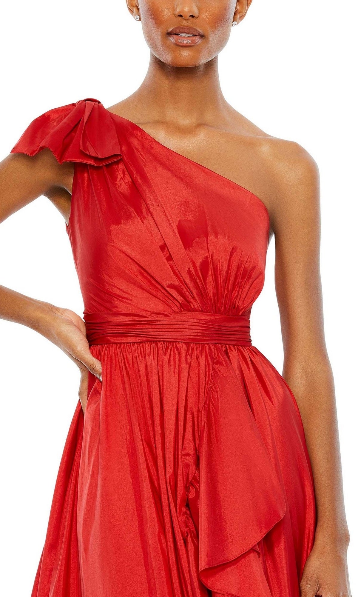A woman wears the Mac Duggal Long Formal Dress 68027—featuring a shiny red, one-shoulder design with a fitted waist and draped, asymmetrical skirt for an elegant look.